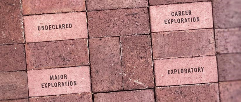 A series of bricks from the USC Horseshow are pictured with phrases etched on them. Phrases include exploratory, major exploration, undeclared, and career exploration. 