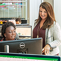 Teacher with Student on Computer in Computer Lab