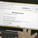 Student taking an online test on laptop