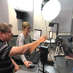 Video and Multimedia Support Instructors collaborating in a video studio to create course content using professional lighting and camera equipment