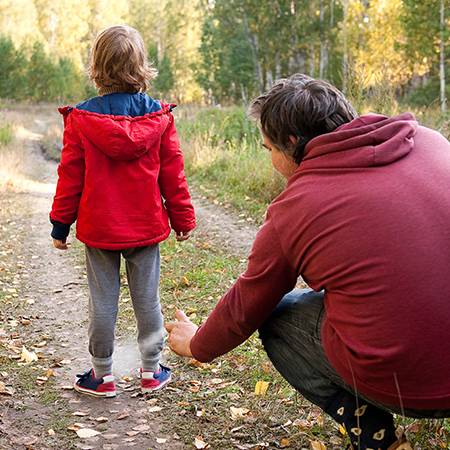 A patent spraying bug spray on a child's ankles.