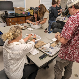 Students cleaning artifacts