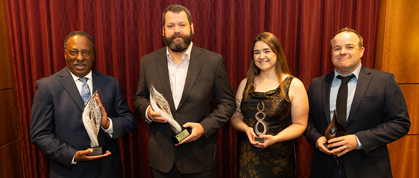 award recipients holding trophies
