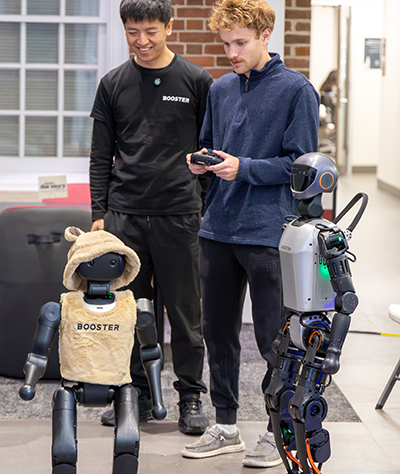 student controlling Booster the robot