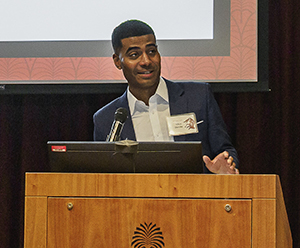 Alumnus Allen Devlin speaking at a podium