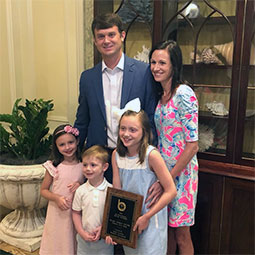 Blake Taylor Blake Taylor stands with his family inside their home. His older daughter holds his award.