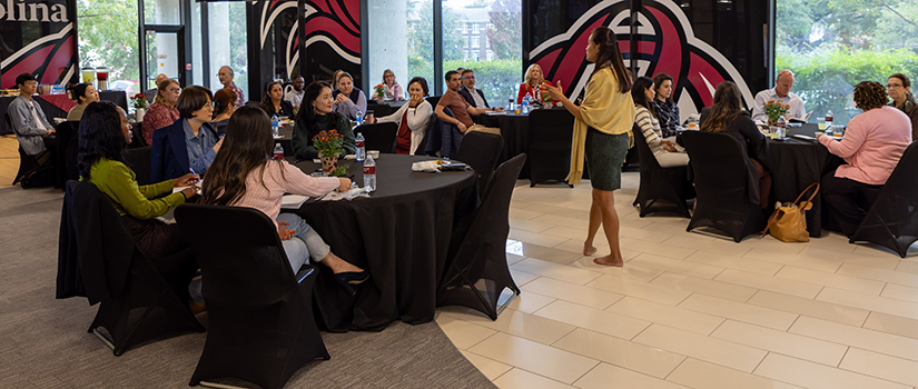 HRSM employees listen to a presenter at a professional development seminar.