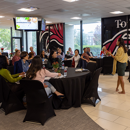 HRSM employees listen to a presenter at a professional development seminar.