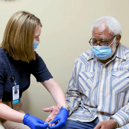 pharmacist with patient in mask