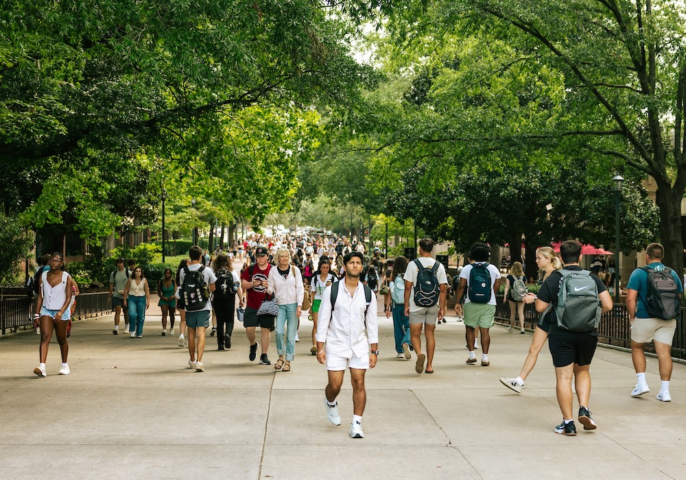 students walking over bridge on USC campus