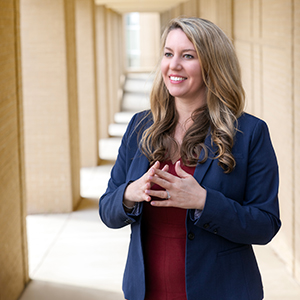 Epidemiologist Melissa Nolan stands outside a building.
