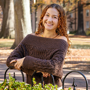 Sophia Dudley leaning on a gate.