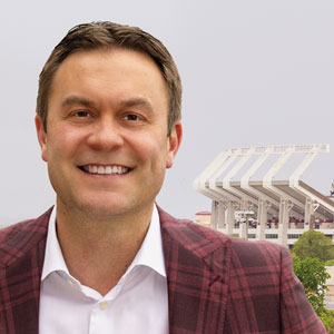 Jeremiah Donati smiles for the camera with Williams-Brice stadium in the background.