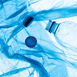 A background of empty plastic water bottles with a blue tint.