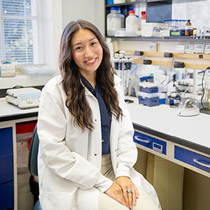 Student sitting at a counter in a research lab
