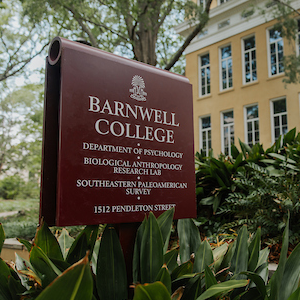 garnet sign reading 'barnwell college, department of psychology, biological anthropology research lab, southeastern paleoamerican survey, 1512 pendleton street' in front of beige building