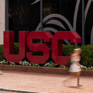garnet block USC letters in front of Russell House